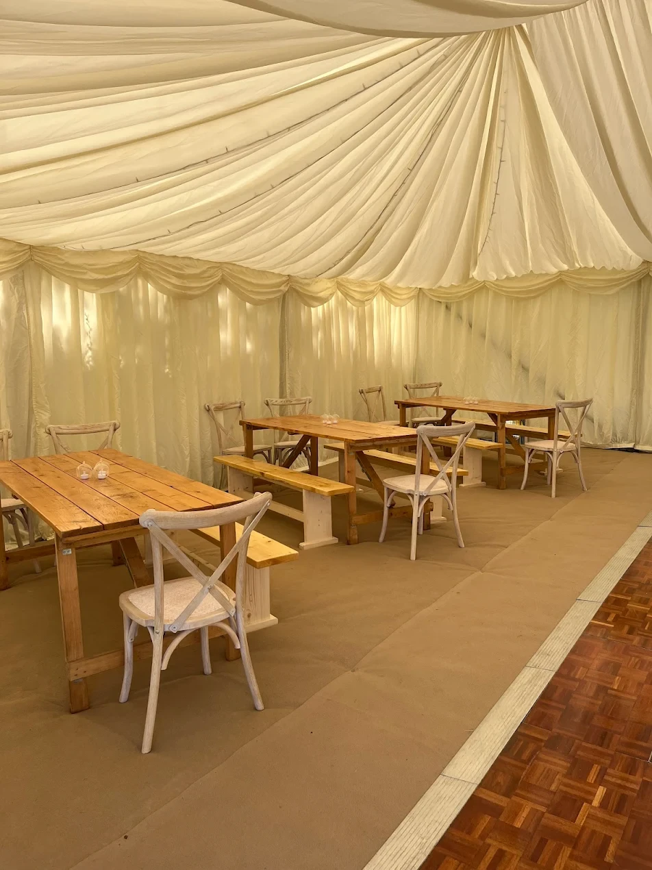 Marquee interior with dance floor and dining setup