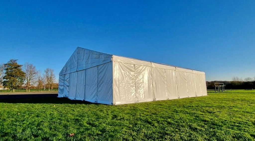 Marquee set up for an event with round tables